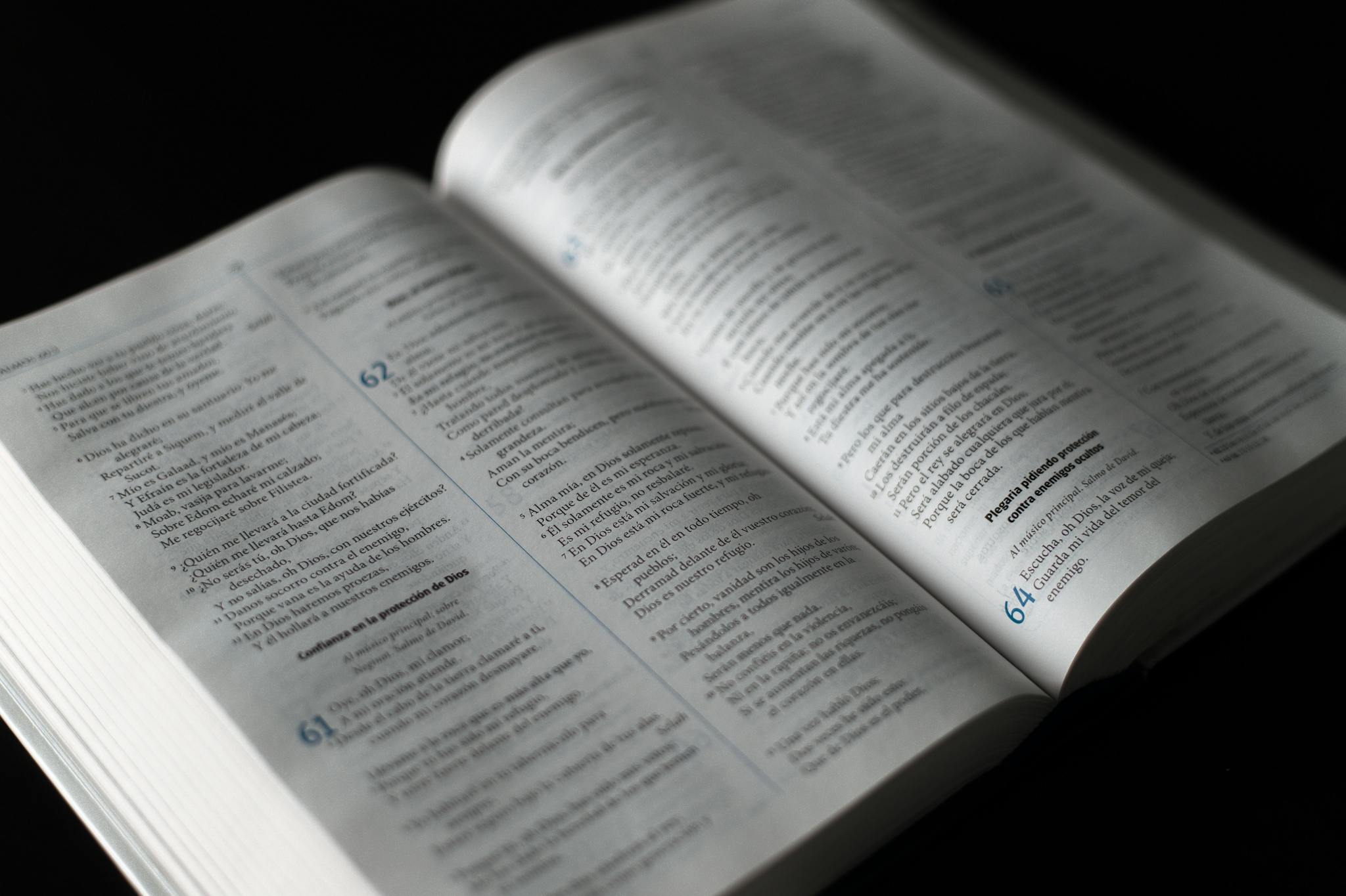 Close-up of an open religious text with highlighted passage, ideal for themes of faith and spirituality.