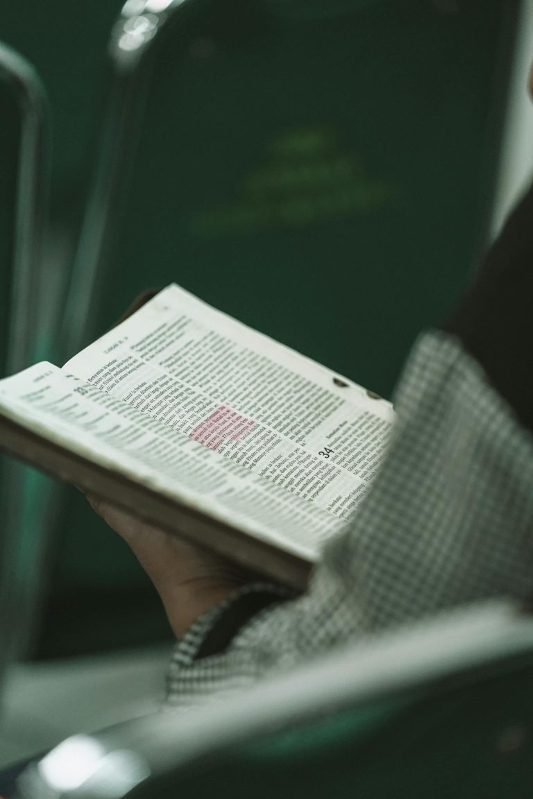 Person holding a Bible during a religious study session in West Java, Indonesia.